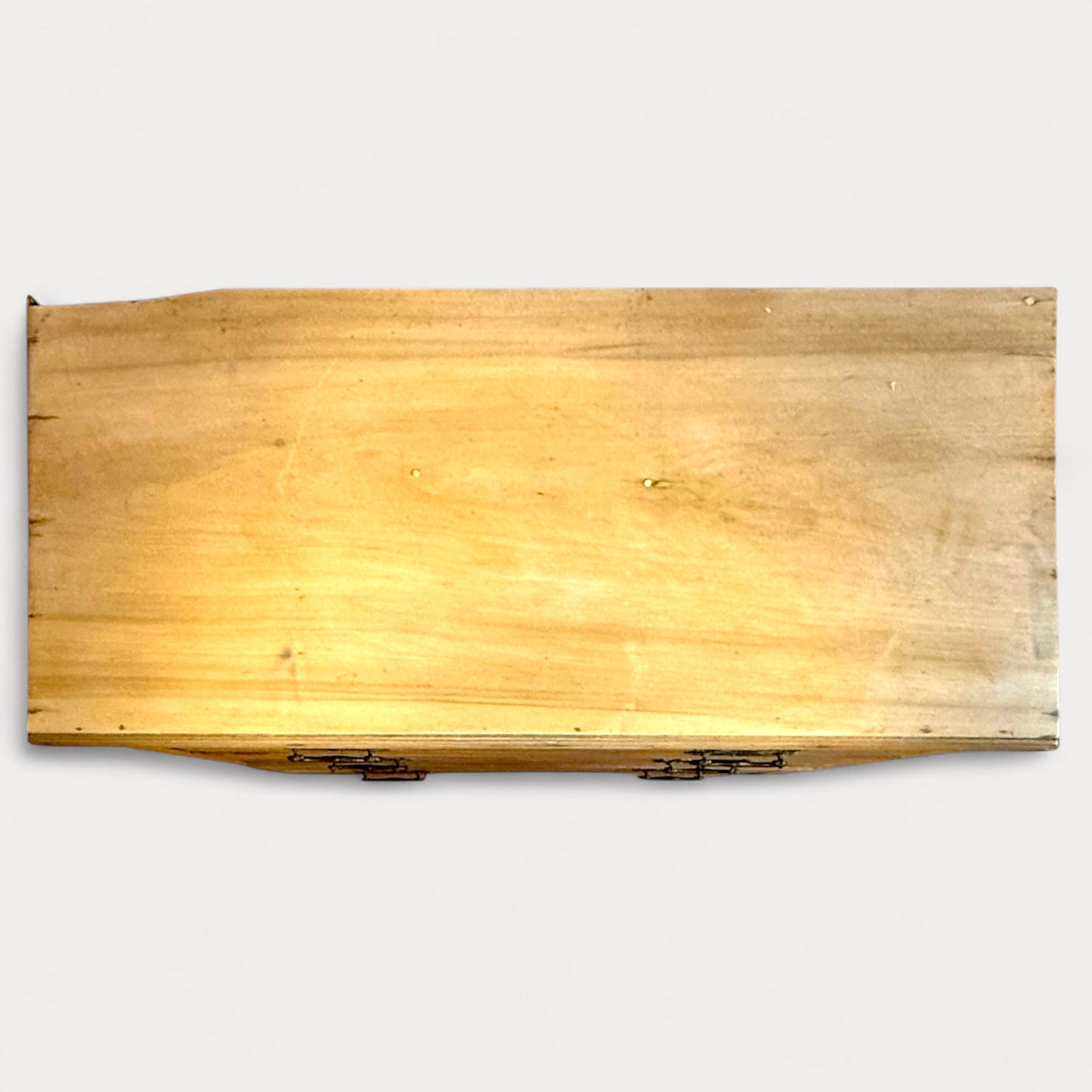 Top surface of antique pine chest showing age-related wear and marks