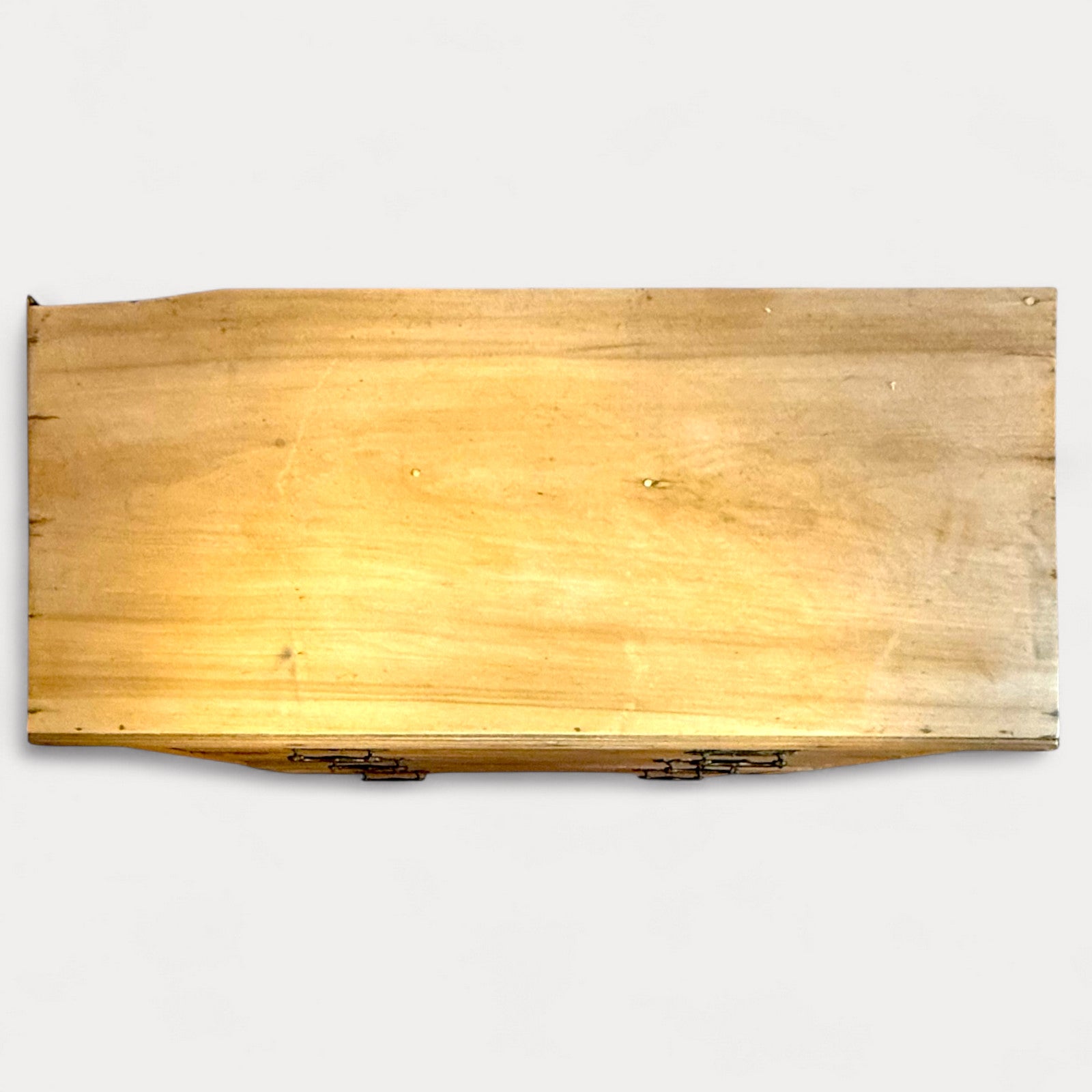 Top surface of antique pine chest showing age-related wear and marks