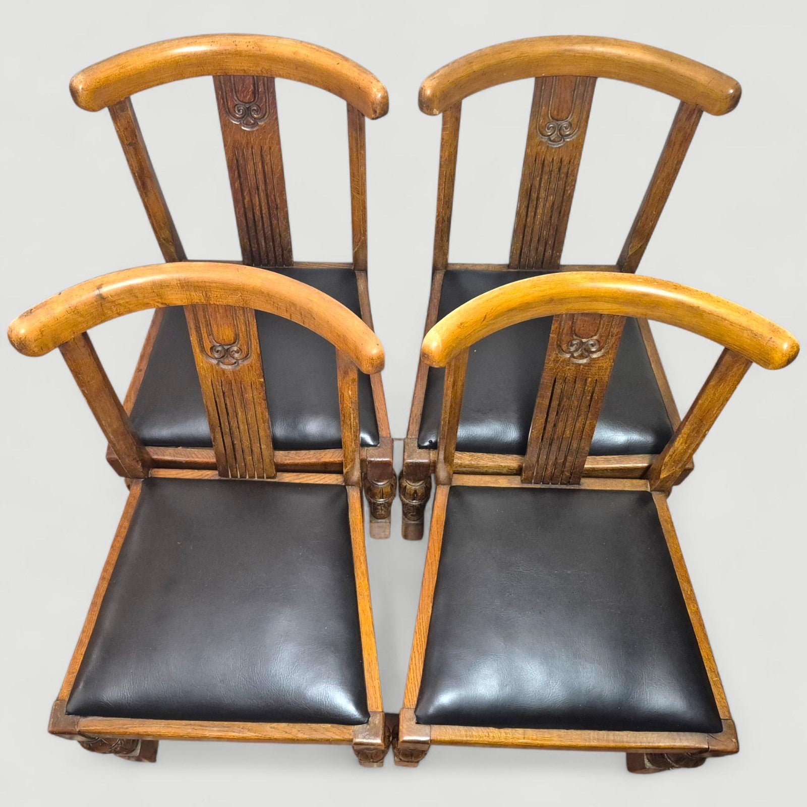 Set of 1920s oak dining chairs arranged in a group – warm patina finish
