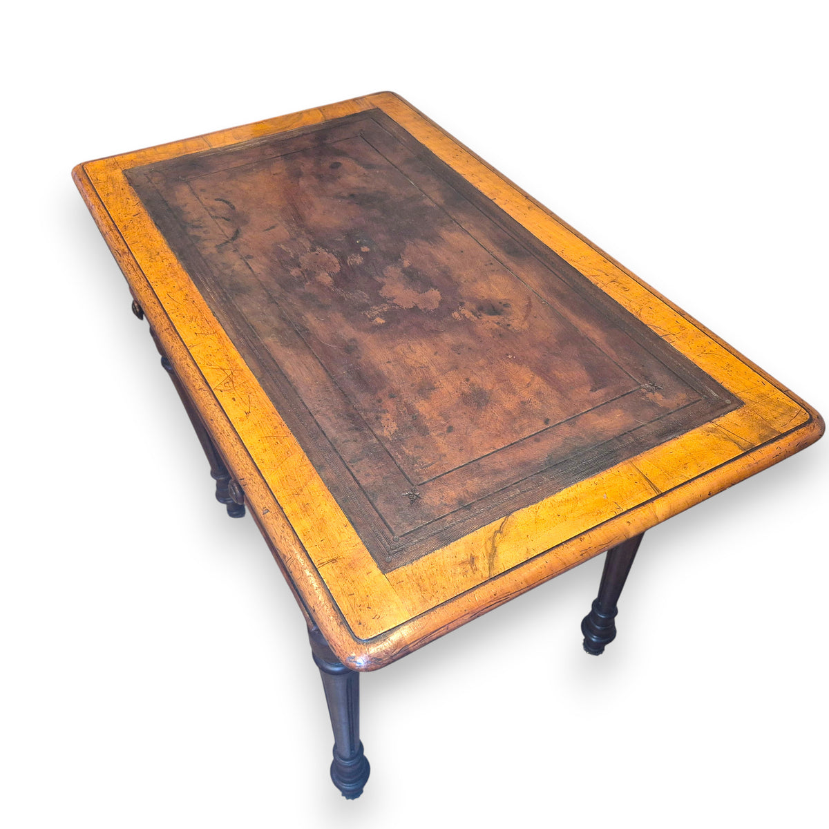 Close view of aged leather writing surface on Victorian walnut desk