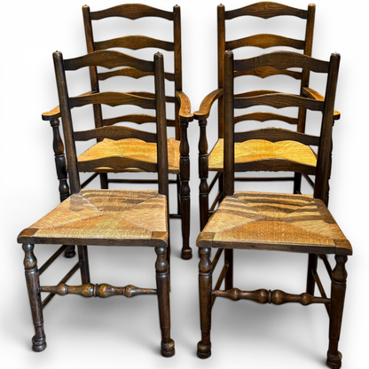 A delightful set of four Early 20th Century Oak Ladder Back Dining Chairs, comprising a matching pair of Oak Carver Chairs and two Side Chairs.