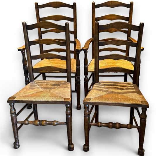 A delightful set of four Early 20th Century Oak Ladder Back Dining Chairs, comprising a matching pair of Oak Carver Chairs and two Side Chairs.