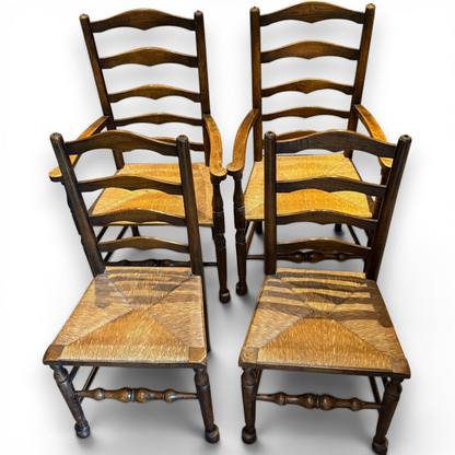 A delightful set of four Early 20th Century Oak Ladder Back Dining Chairs, comprising a matching pair of Oak Carver Chairs and two Side Chairs.