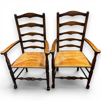 A delightful set of four Early 20th Century Oak Ladder Back Dining Chairs, comprising a matching pair of Oak Carver Chairs and two Side Chairs.