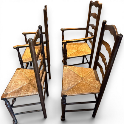 A delightful set of four Early 20th Century Oak Ladder Back Dining Chairs, comprising a matching pair of Oak Carver Chairs and two Side Chairs.