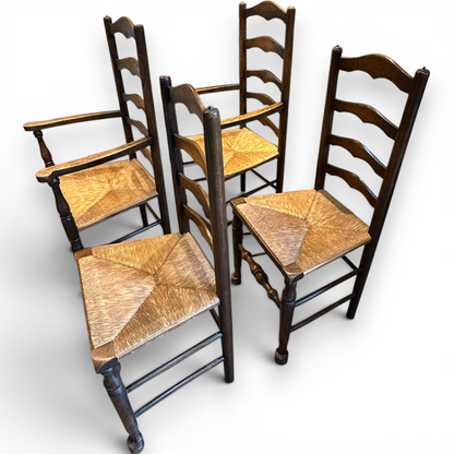 A delightful set of four Early 20th Century Oak Ladder Back Dining Chairs, comprising a matching pair of Oak Carver Chairs and two Side Chairs.