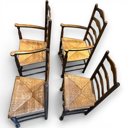 A delightful set of four Early 20th Century Oak Ladder Back Dining Chairs, comprising a matching pair of Oak Carver Chairs and two Side Chairs.