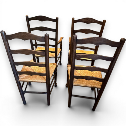 A delightful set of four Early 20th Century Oak Ladder Back Dining Chairs, comprising a matching pair of Oak Carver Chairs and two Side Chairs.