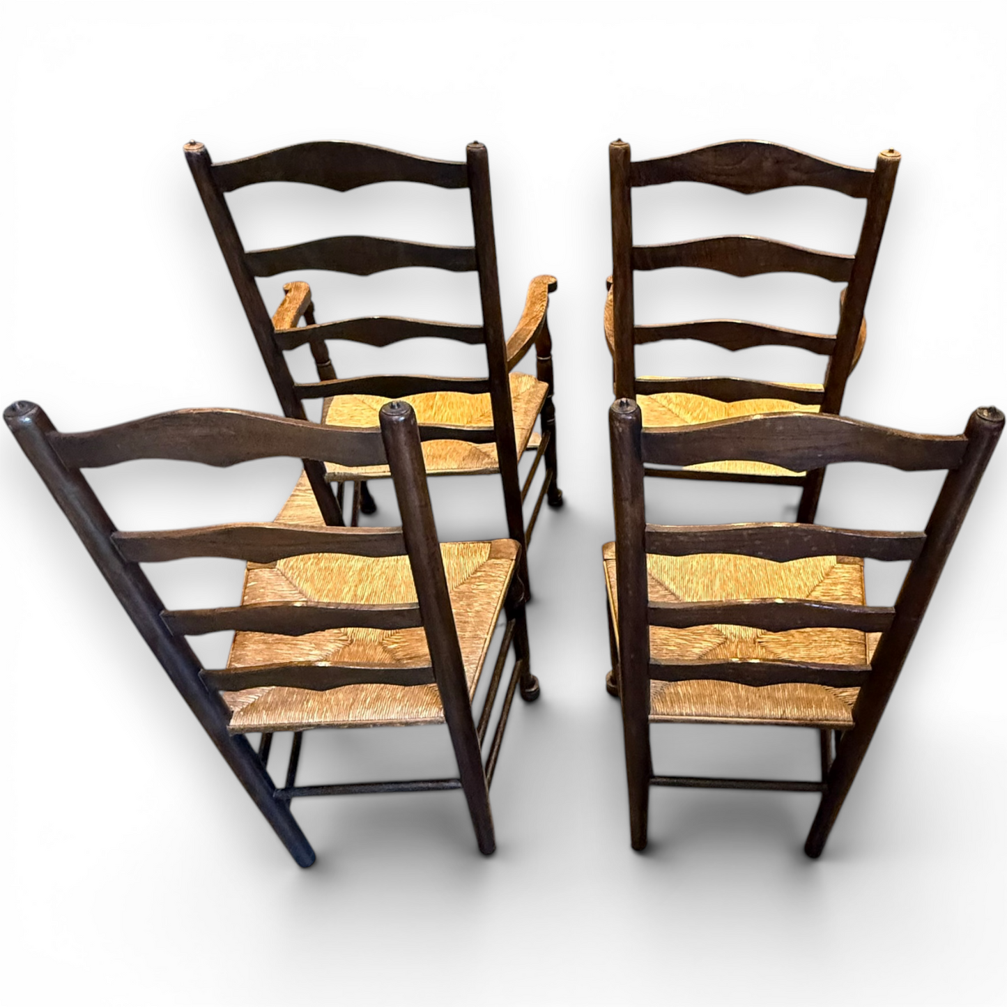 A delightful set of four Early 20th Century Oak Ladder Back Dining Chairs, comprising a matching pair of Oak Carver Chairs and two Side Chairs.
