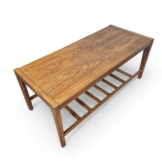 Vintage Remploy teak coffee table with slatted lower shelf and tapered legs — mid-century modern Scandinavian-inspired design.