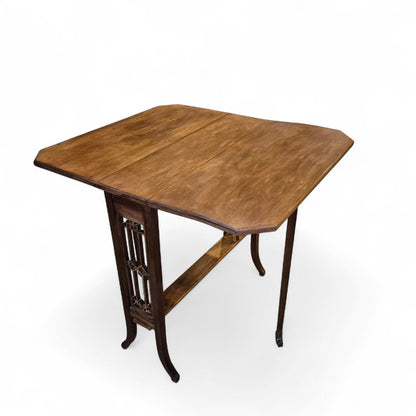 Antique mahogany Sutherland drop-leaf table with elegant Victorian design, cut-out end supports, and splayed legs on original castors – late 19th century by Avego Antiques.