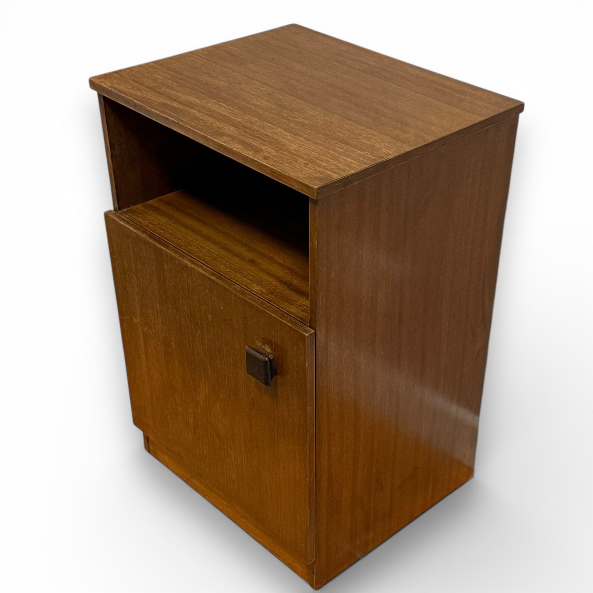 Angled view of Mid century Remploy teak bedside cabinet with open shelf and cupboard