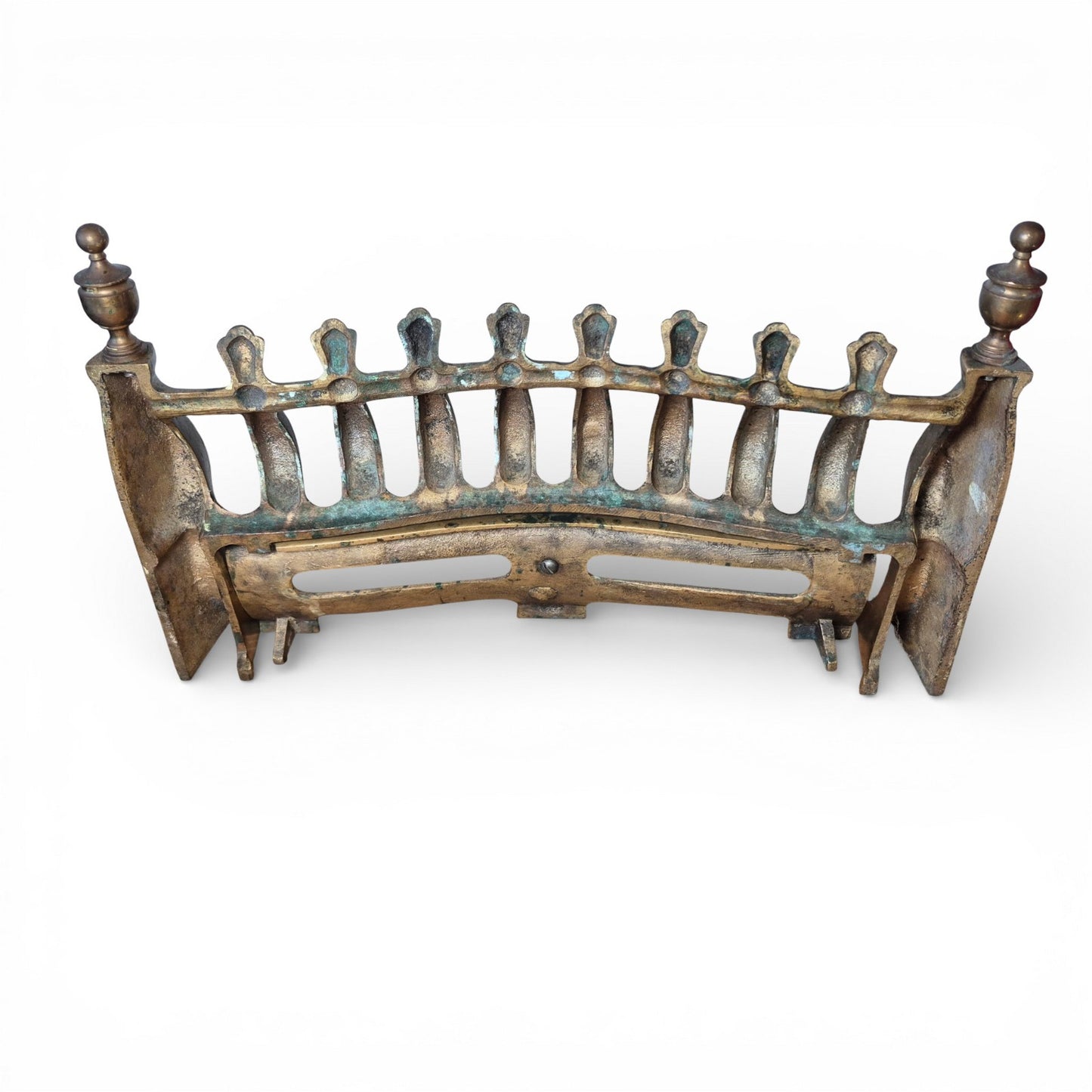 Antique brass fire grate showing verdigris and wear