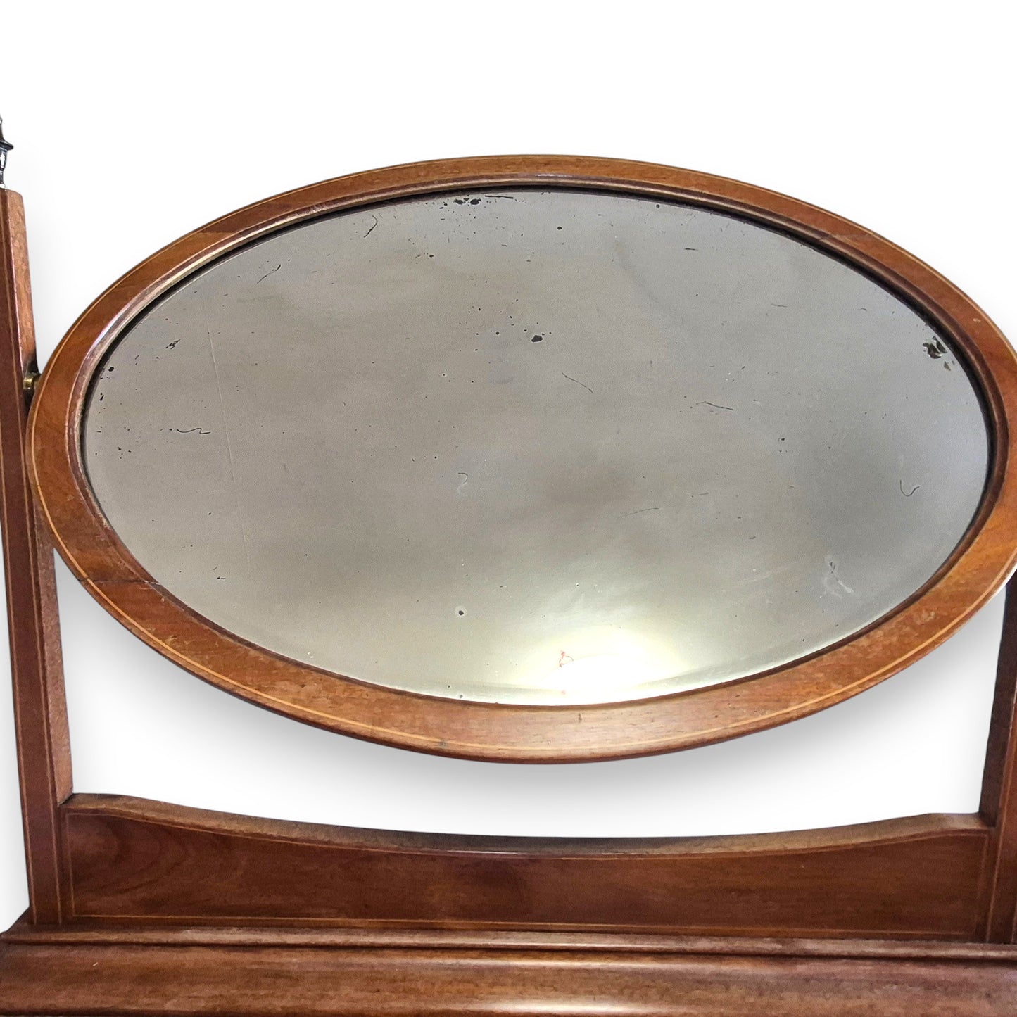 Close up of foxed bevelled mirror on antique Edwardian dressing table