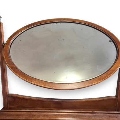Close up of foxed bevelled mirror on antique Edwardian dressing table