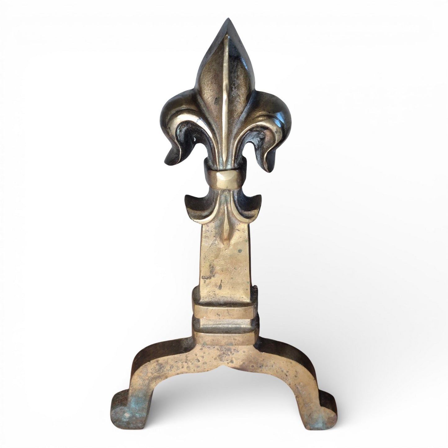 Detail of brass fleur-de-lis finial on antique fire grate