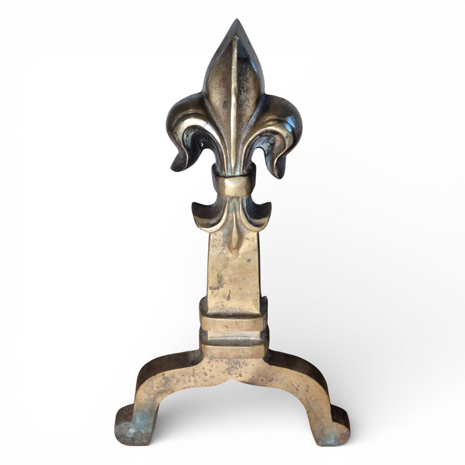 Detail of brass fleur-de-lis finial on antique fire grate