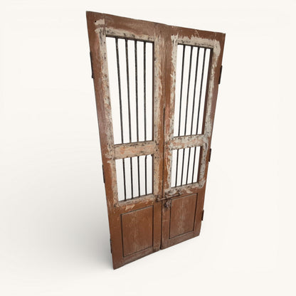 Pair of antique Indian jali doors with vertical iron bars and aged timber frames, 182cm tall reclaimed architectural salvage panels.