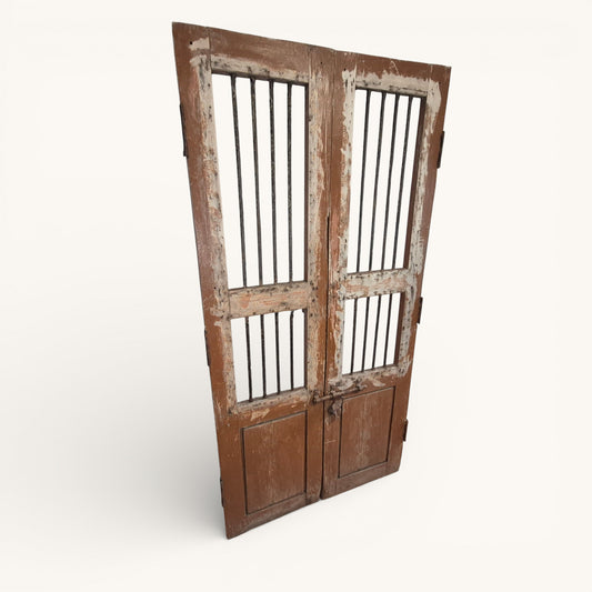 Pair of antique Indian jali doors with vertical iron bars and aged timber frames, 182cm tall reclaimed architectural salvage panels.
