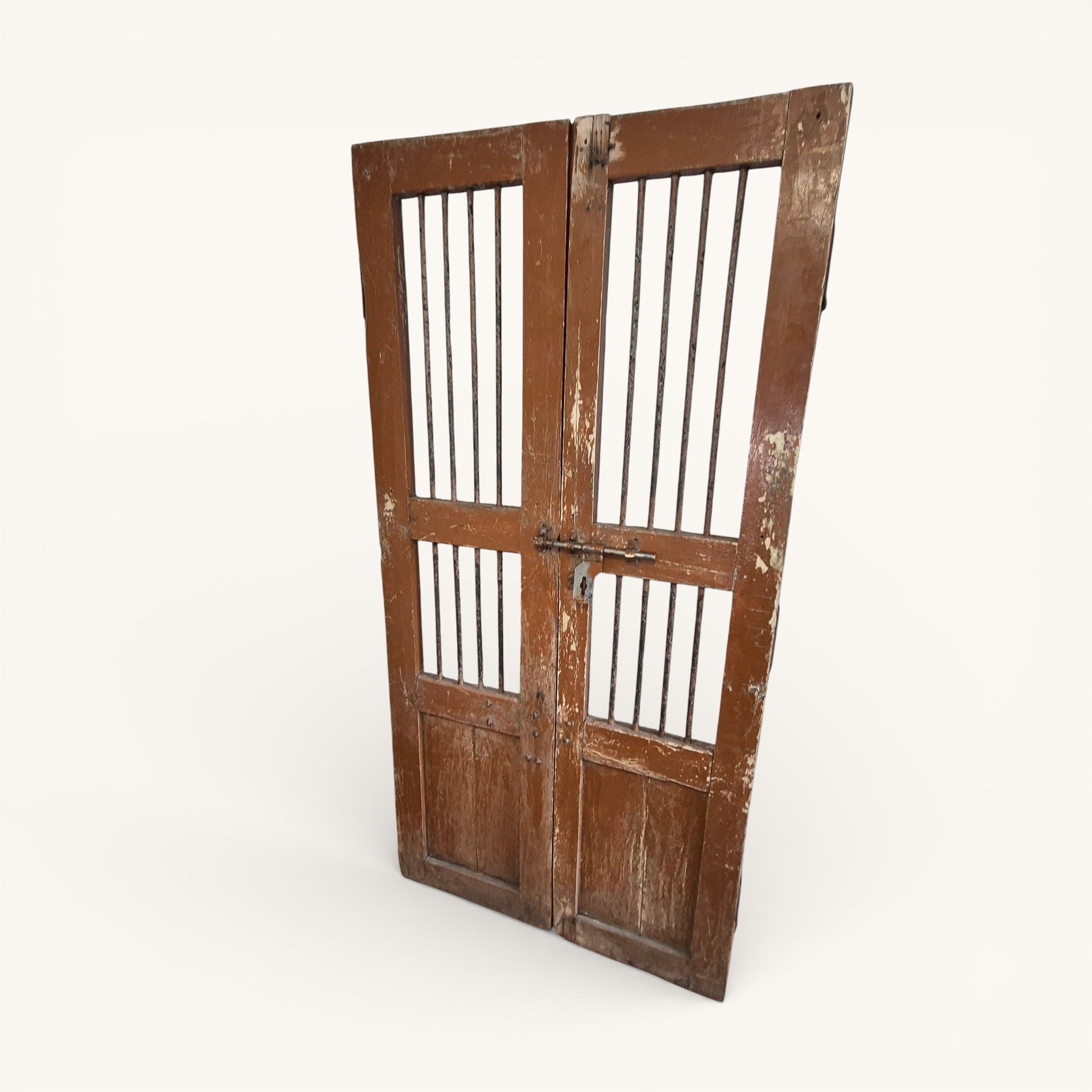 Full front view of pair of antique Indian jali doors with iron bars and original hardware, reclaimed architectural salvage.