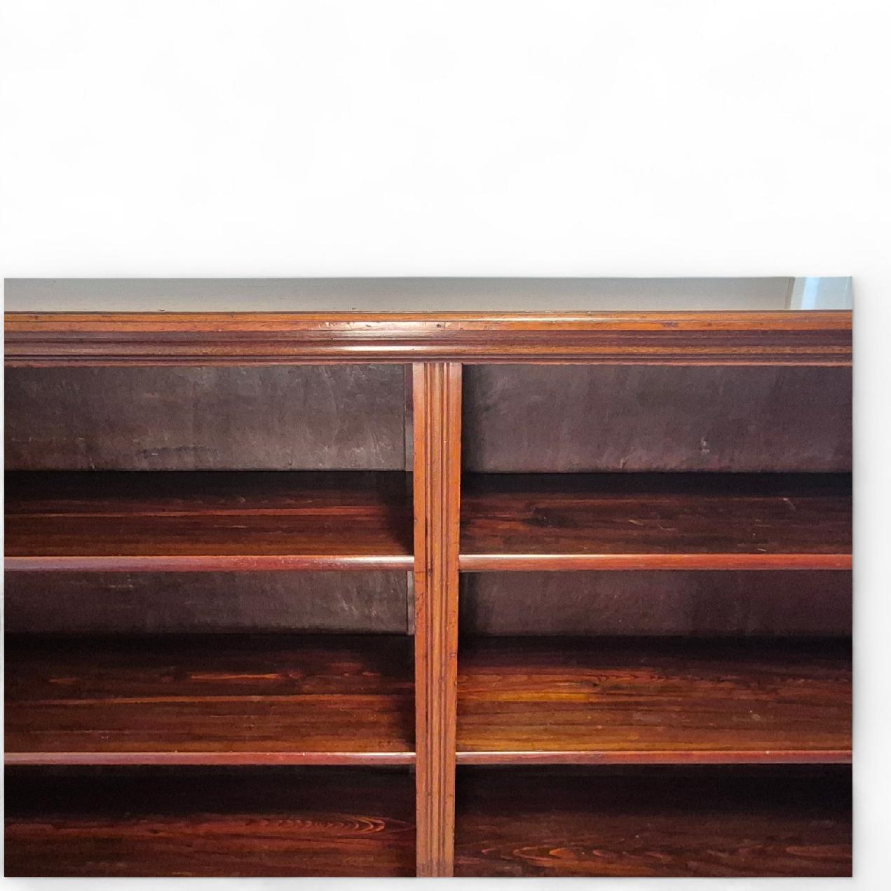 Detail of moulded top and plinth base on Victorian mahogany open bookcase