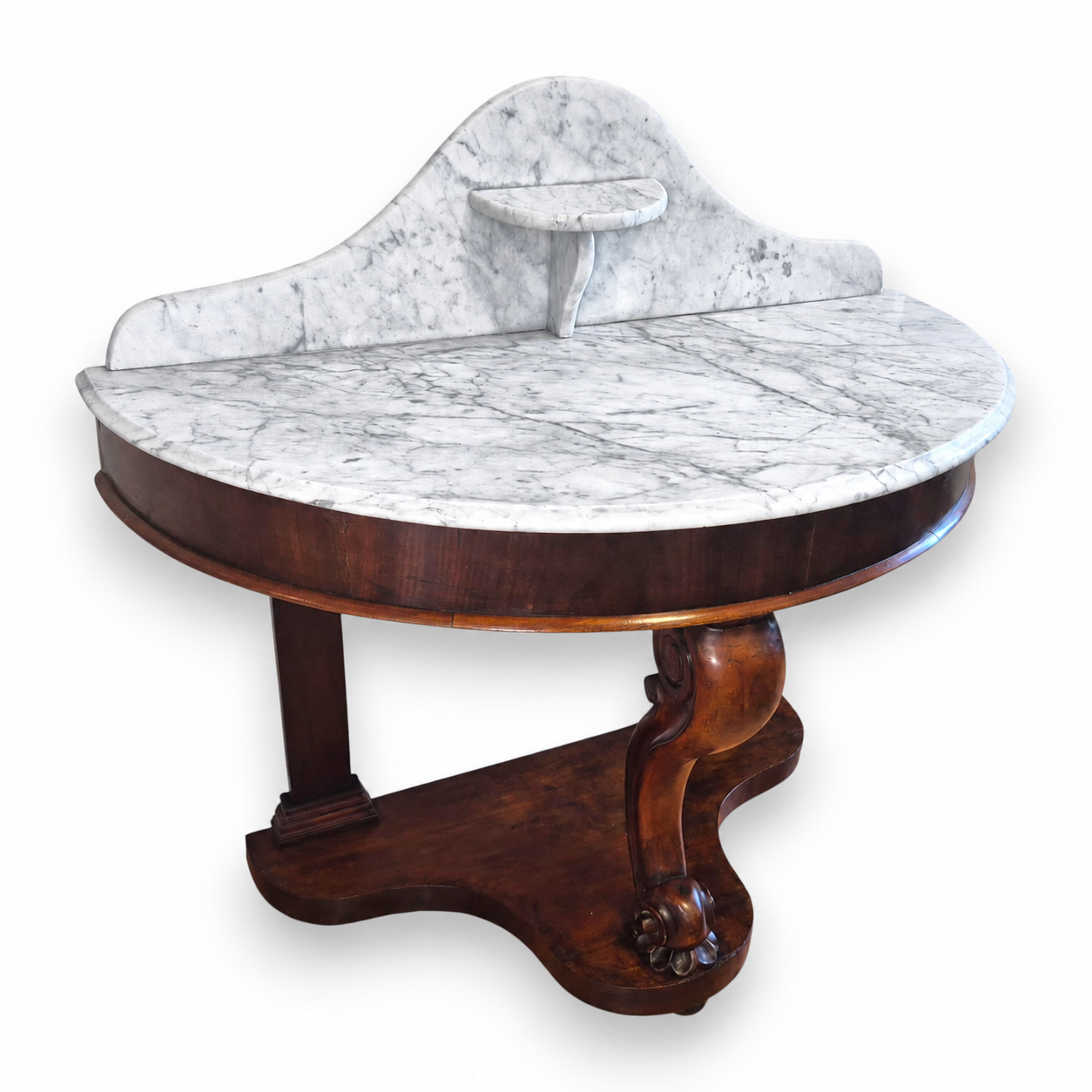 Antique Victorian mahogany demi-lune washstand with a veined white marble top and shaped marble backstand.