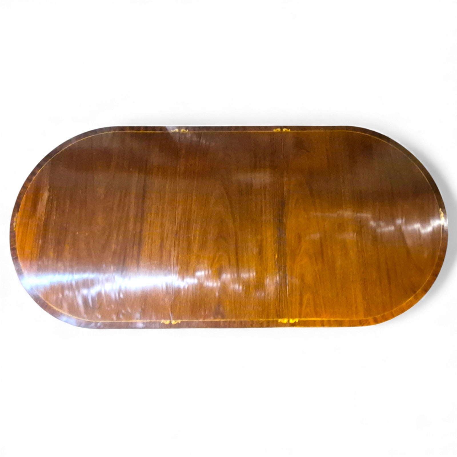 Regency mahogany dining table showing oval top and brass inlay edge