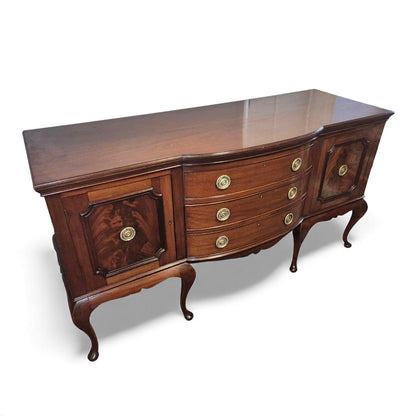 Front view of mahogany sideboard showing cupboards and central drawers
