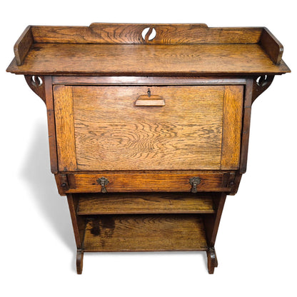 Antique solid oak Arts and Crafts bureau desk – front view showing drop-front and shelves