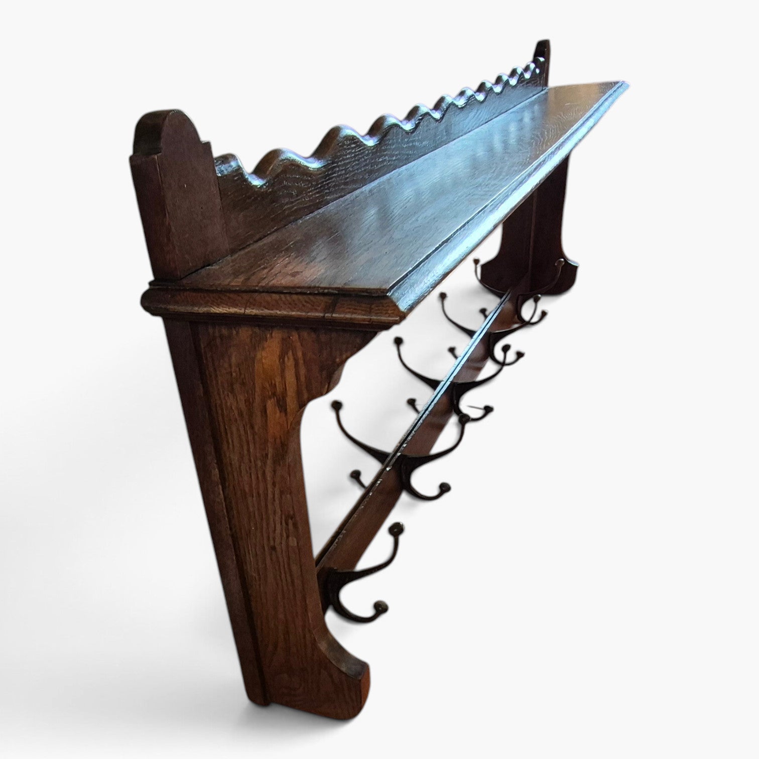 Side view showing the depth and shaped supports of antique oak coat rack