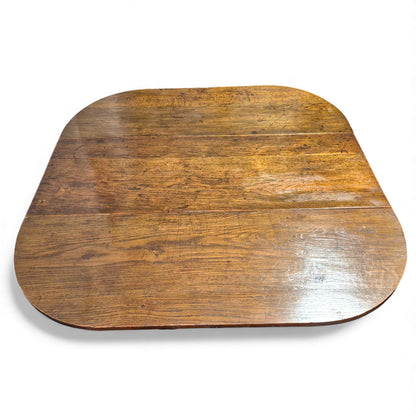 Close-up of aged oak grain and surface wear on antique plank top