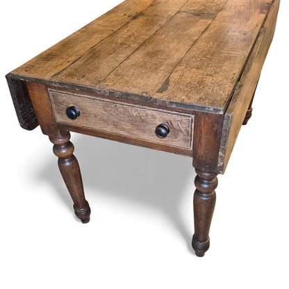 Antique oak table with dual drawers and turned leg base