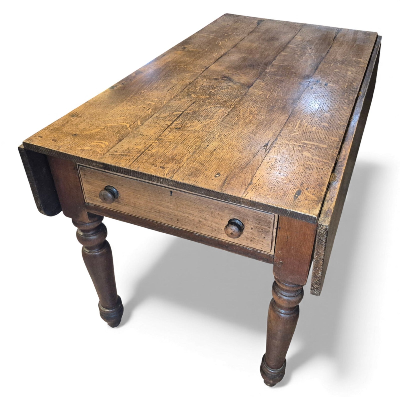Antique oak farmhouse kitchen table with plank top and drop-leaf sides