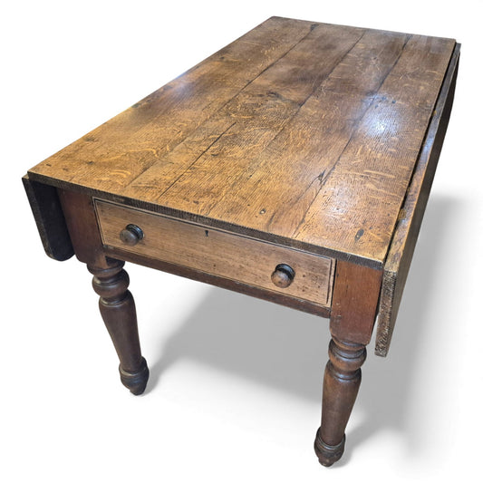 Antique oak farmhouse kitchen table with plank top and drop-leaf sides