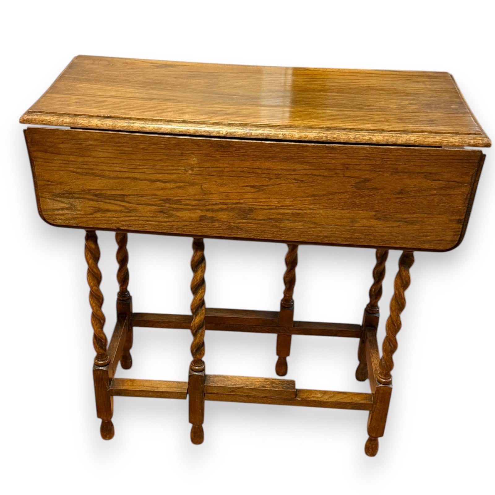Side view of early 20th-century oak gateleg table showing folded leaf