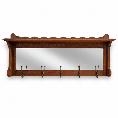 Front view of antique oak hall rack with mirror and coat hooks