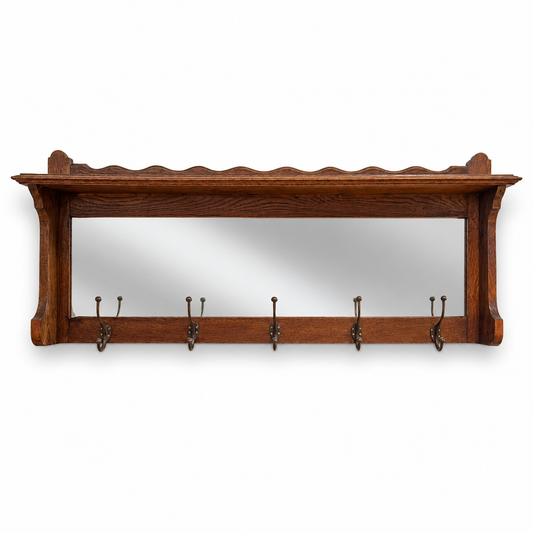 Front view of antique oak hall rack with mirror and coat hooks