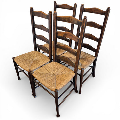 Set of four antique oak ladderback chairs with rush seats