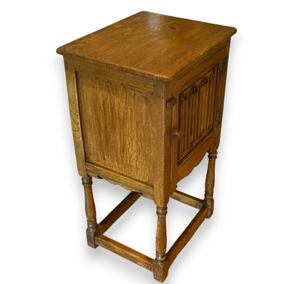 Early 20th century oak cupboard – angled view highlighting turned legs and warm patina