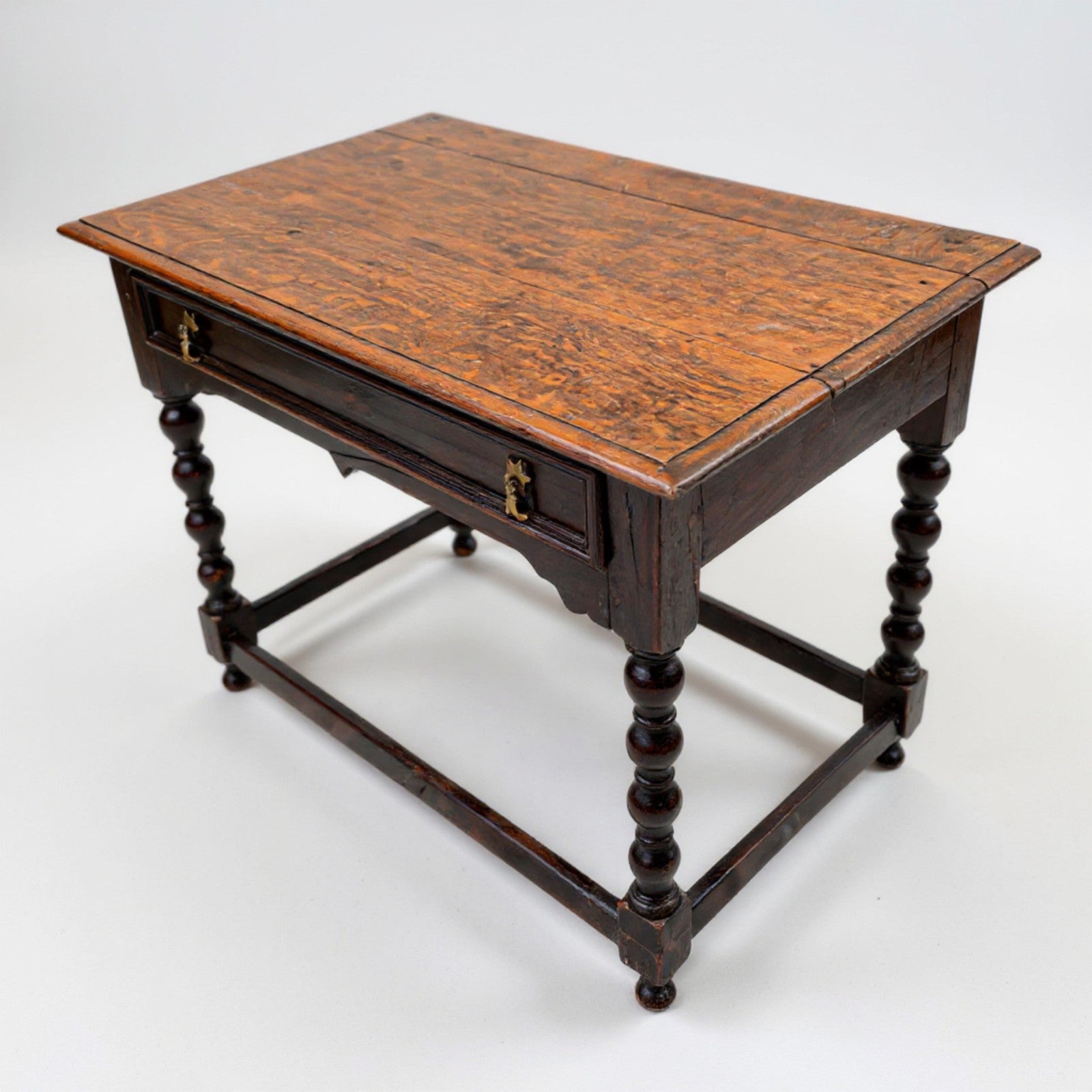 Antique oak side table with a rich patina, turned legs, and sturdy stretcher base.