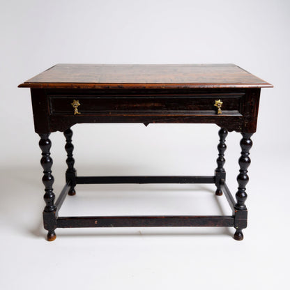 Detail of turned oak legs and stretcher base on 18th-century style antique side table — rustic handmade character.