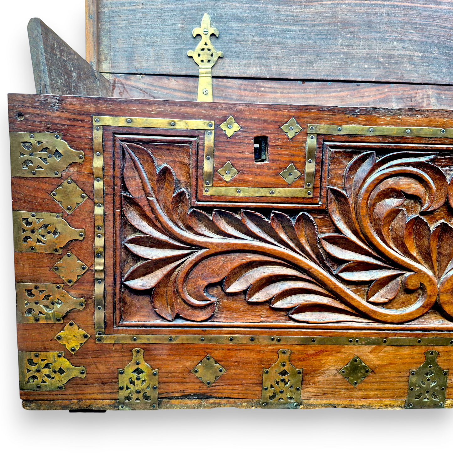 Close-up of decorative brass mounts on antique padouk blanket box