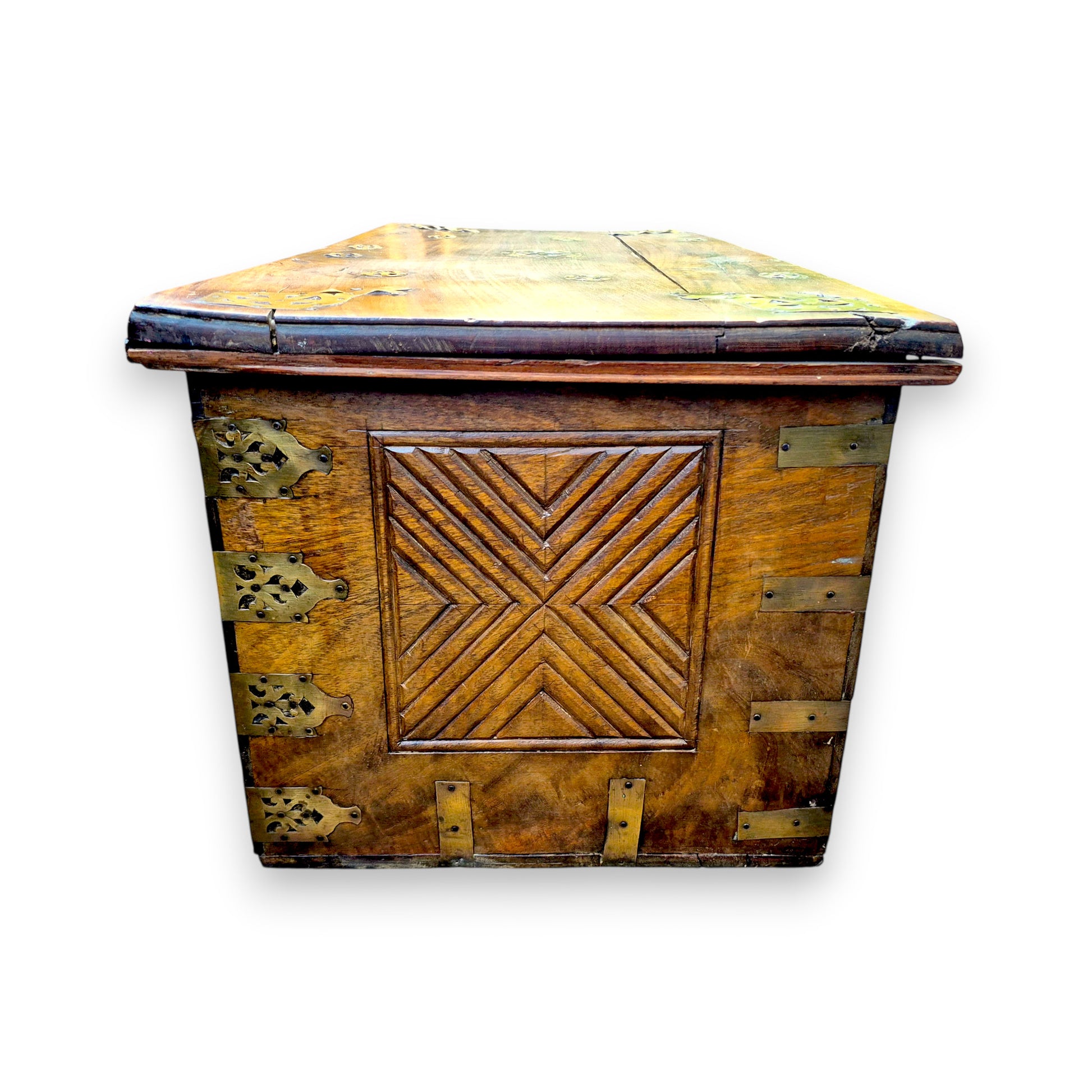 End view of antique padouk chest showing geometric carved panel