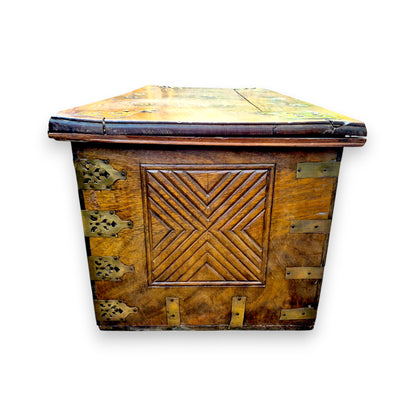 End view of antique padouk chest showing geometric carved panel