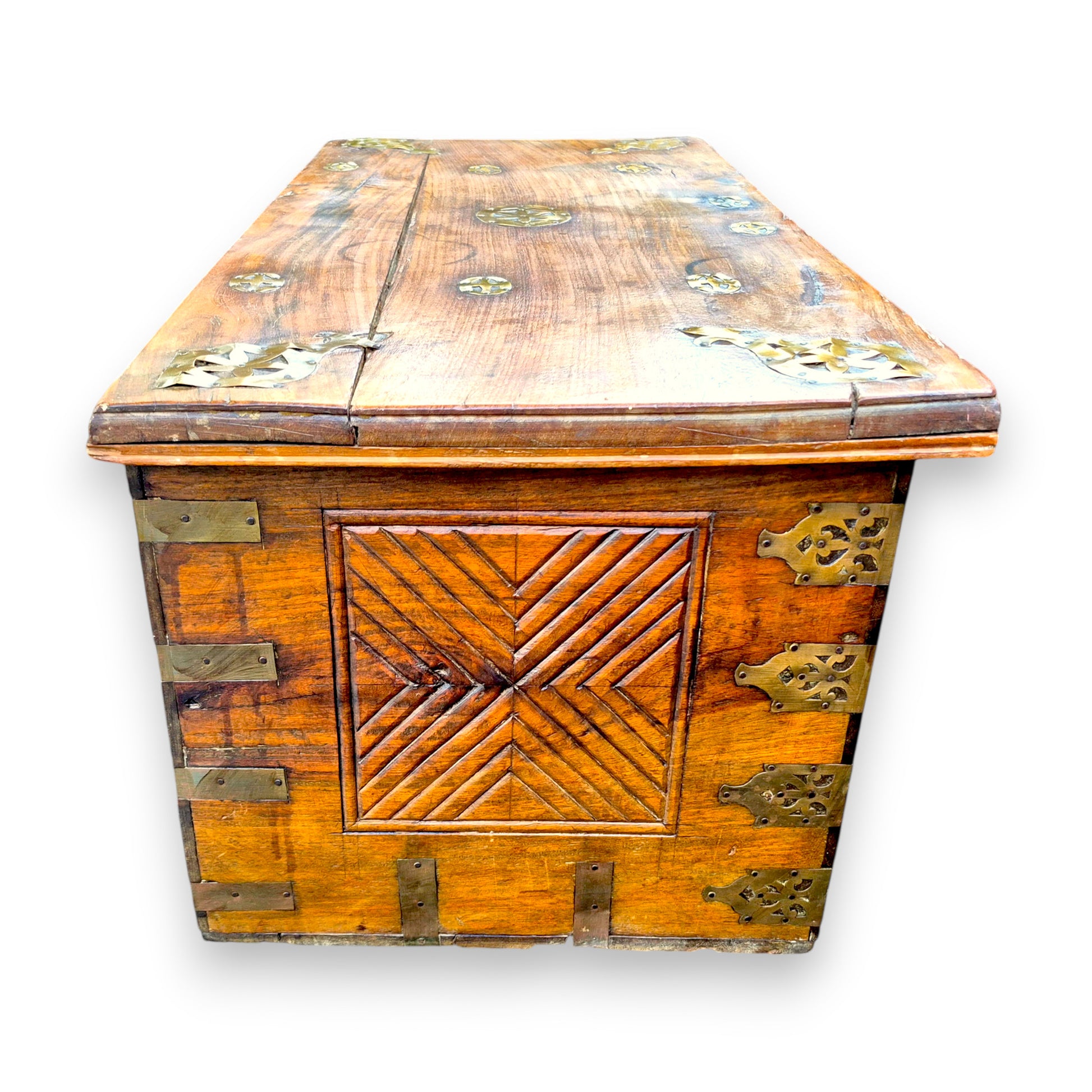 Side view of antique padouk chest showing geometric carved panel