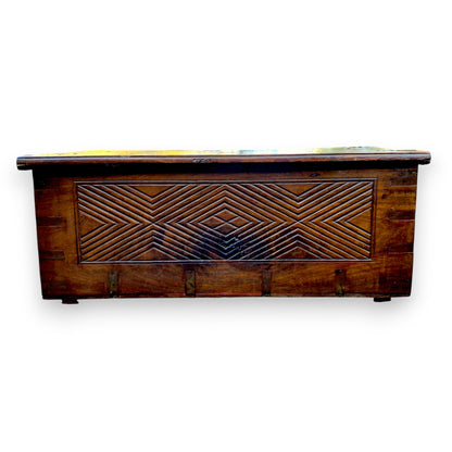 Rear view of antique padouk chest showing geometric carved panel