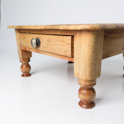 Side profile showing table drawer proportions and natural wood grain