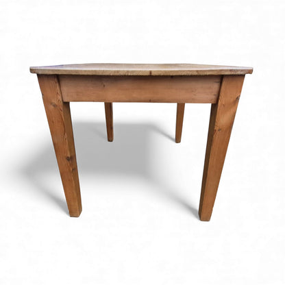 Side view of antique pine table with tapered legs