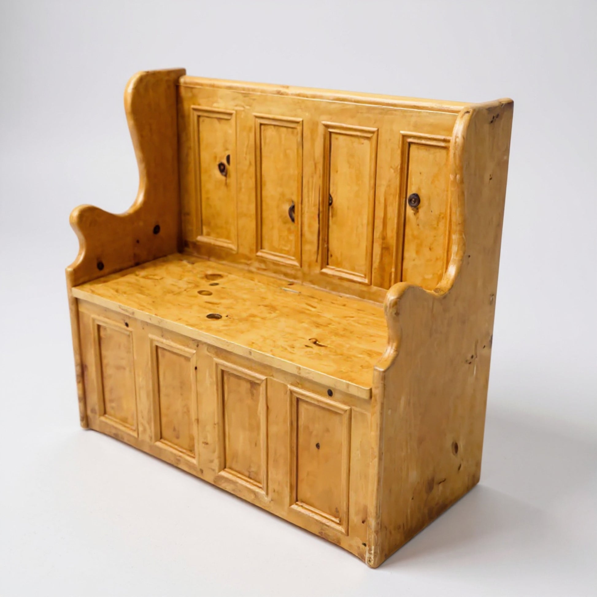 Front view of vintage pine storage bench showing panelled design