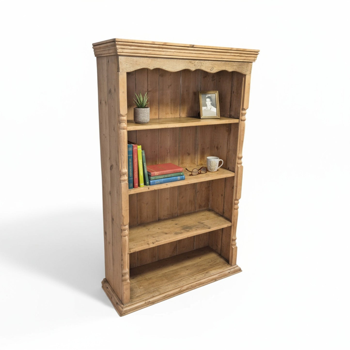Rustic pine bookcase – angled view highlighting turned supports and aged finish